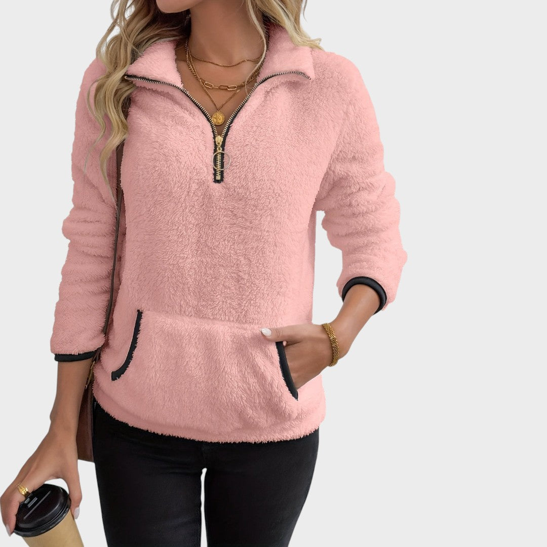 Modelo veste casaco de malha rosa Lars Hamburg com fecho de correr, gola alta e bolso frontal estilo canguru.