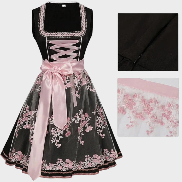 Dirndl Lars Hamburg preto com avental de renda floral rosa, laço de cetim e detalhes bordados para Oktoberfest.