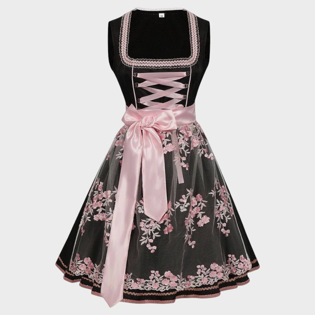 Dirndl Lars Hamburg preto com avental de tule rosa, bordados florais e laço de cetim, ideal para Oktoberfest.