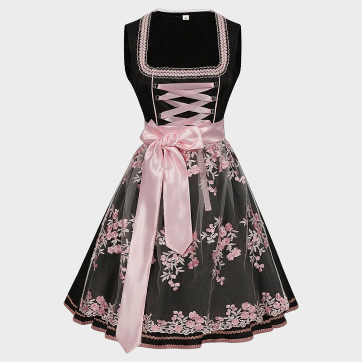 Dirndl Lars Hamburg preto com avental de tule rosa, bordados florais e laço de cetim, ideal para Oktoberfest.