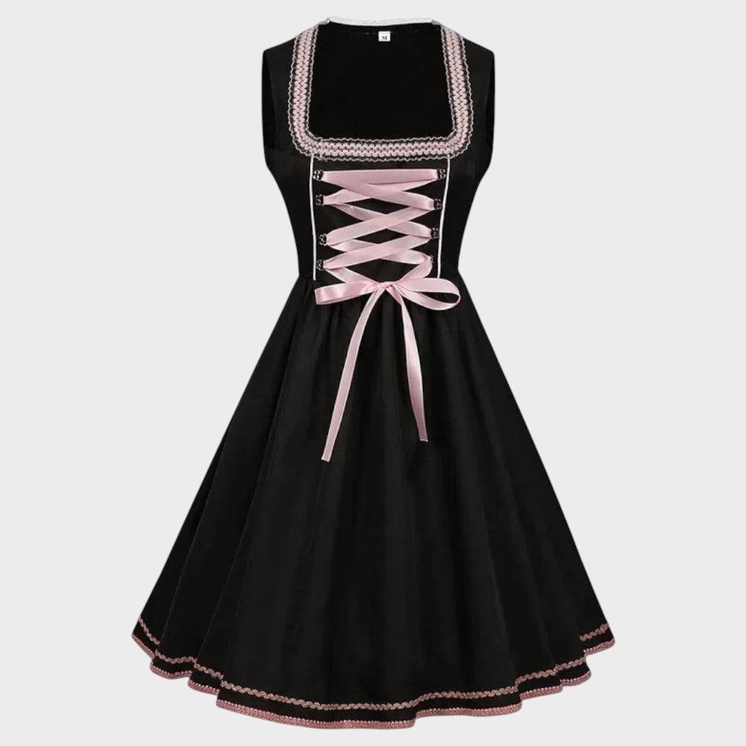 Dirndl Walli da marca Lars Hamburg em preto com detalhes em rosa claro, laço frontal e padrão floral discreto.