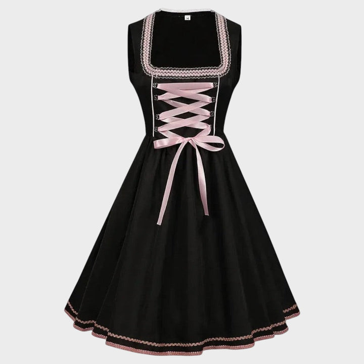 Dirndl Walli da marca Lars Hamburg em preto com detalhes em rosa claro, laço frontal e padrão floral discreto.
