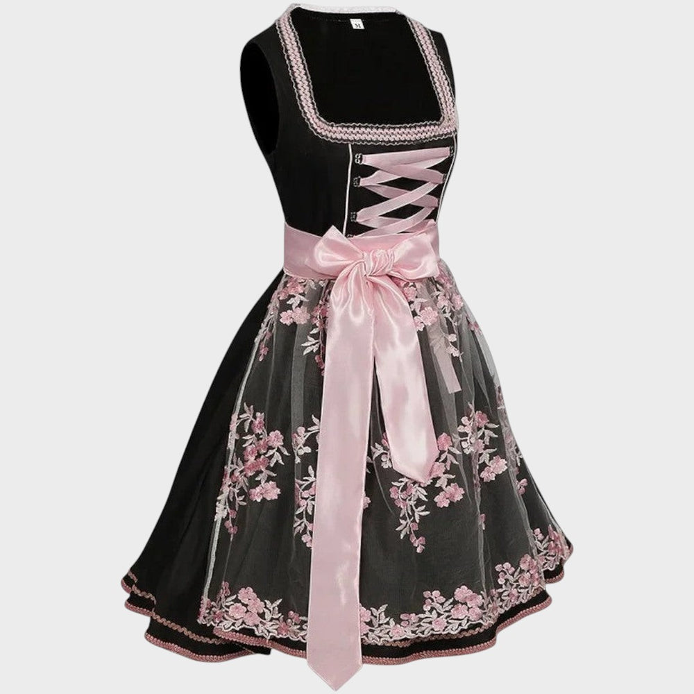 Dirndl Lars Hamburg preto com avental de renda rosa, bordados florais e laço de cetim, ideal para Oktoberfest.