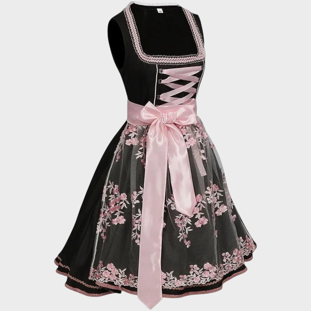 Dirndl Lars Hamburg preto com avental de renda rosa, bordados florais e laço de cetim, ideal para Oktoberfest.