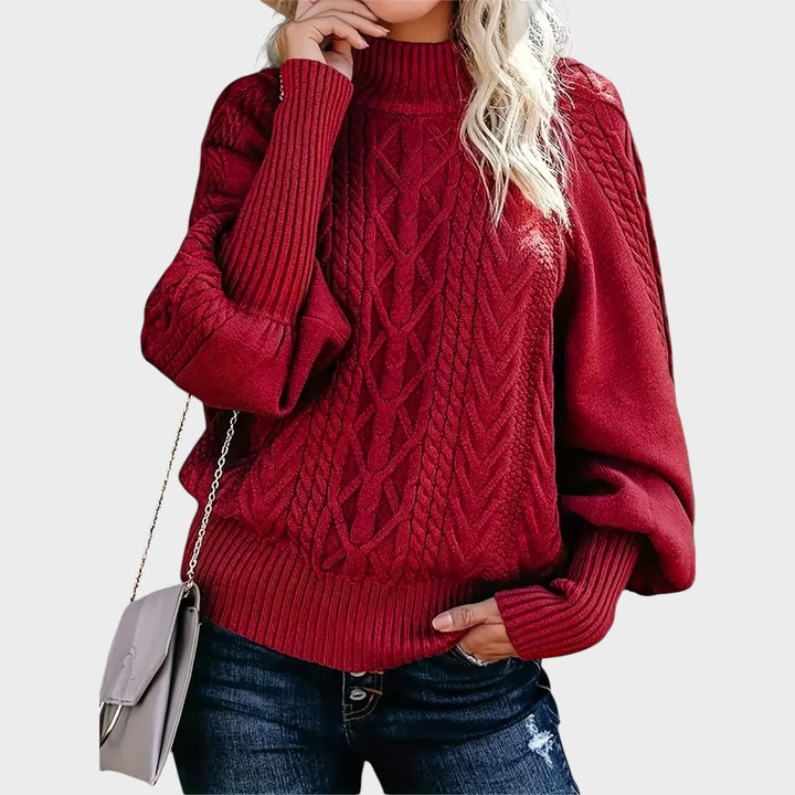 Pullover de malha vermelho com padrão de tranças da Lars Hamburg, corte largo e mangas compridas.