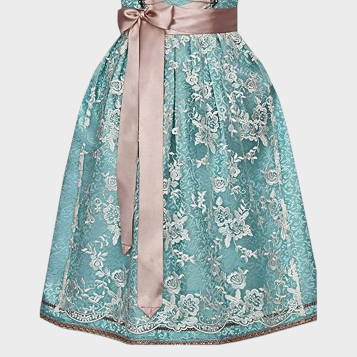 Saia midi turquesa com bordados florais detalhados e avental rosa acetinado do traje tradicional Lars Hamburg