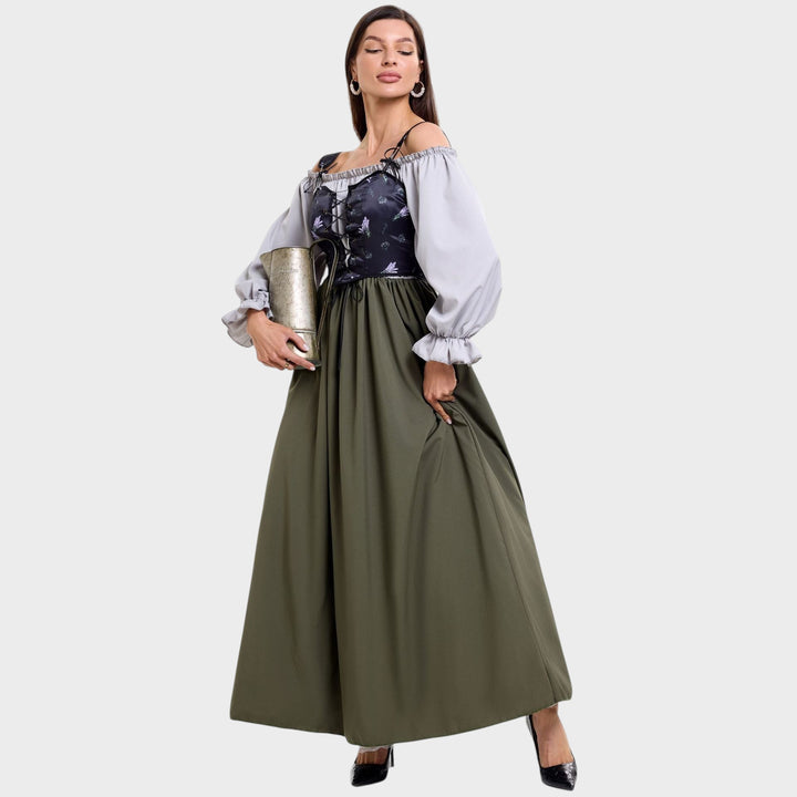 Modelo veste vestido Trachten Lars Hamburg com corpete floral, mangas bufantes cinzentas e saia longa verde oliva