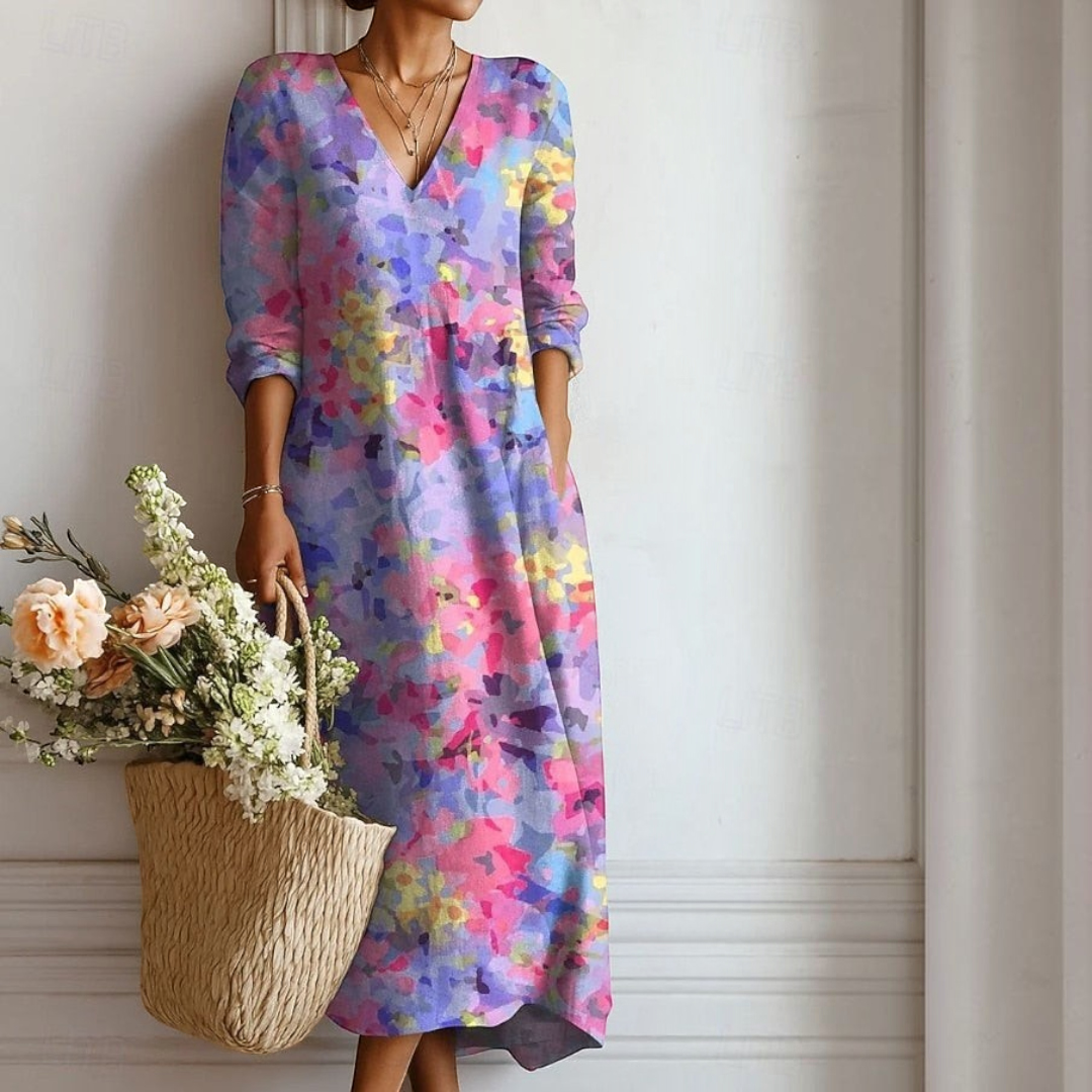 Vestido boho Lars Hamburg Ingrid em tons de purpura com padrão floral colorido, corte midi e bolsos laterais.