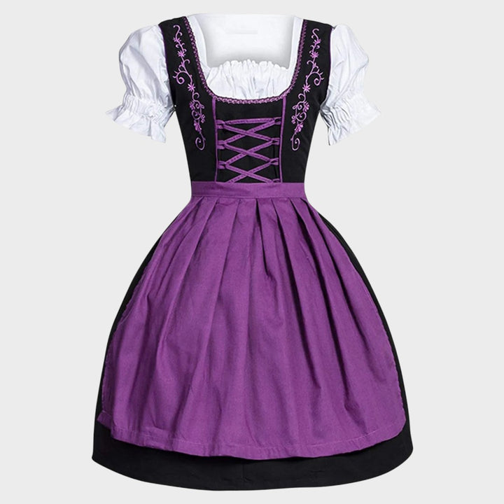 Vestido Dirndl Lars Hamburg para Oktoberfest em preto e roxo com blusa branca, bordados florais e laço frontal.