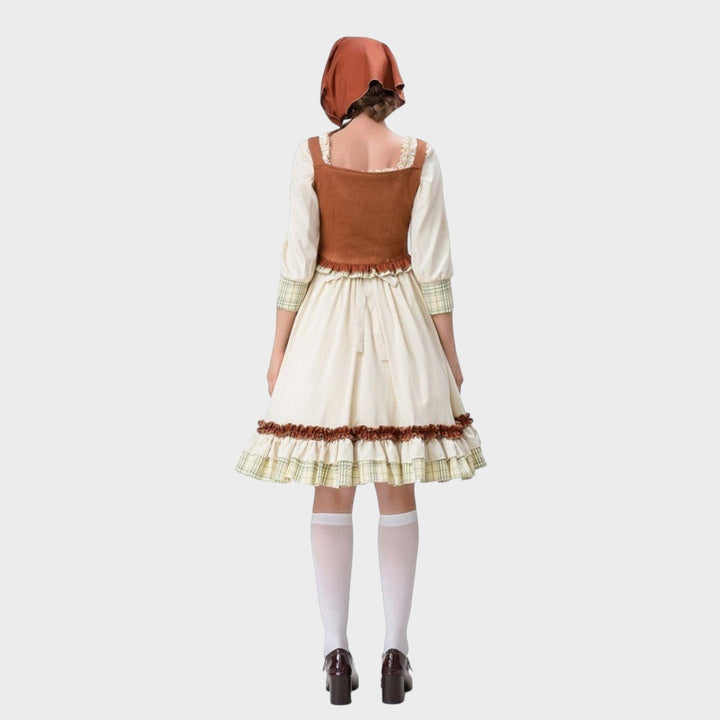 Vista traseira do vestido tradicional Gundi da Lars Hamburg com corpete castanho, saia bege e touca a condizer.